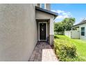Inviting front door with a decorative wreath and brick walkway at 3172 Jade Tree Pt, Oviedo, FL 32765