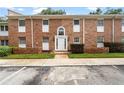 Attractive two-story brick building featuring rows of windows, a decorative entryway, and neat landscaping at 4312 Lake Underhill Rd # 19-B, Orlando, FL 32803