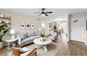 Bright living room boasts a stylish ceiling fan, wood flooring and contemporary furnishings that fill the space at 4312 Lake Underhill Rd # 19-B, Orlando, FL 32803
