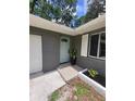 Inviting front entrance featuring a teal door, white trim, and brick accents at 4883 Cherokee Rose Dr, Orlando, FL 32808