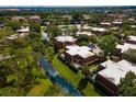 Aerial view of townhouses and a serene waterway in a vibrant community at 5287 Cypress Ct # 724, Orlando, FL 32811