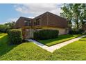 Charming exterior of the townhouse with a courtyard, fenced yard and green lawn at 5287 Cypress Ct # 724, Orlando, FL 32811