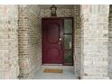 A charming brick home featuring a decorative front door and welcoming 'Welcome' mat at 687 N Endeavour Dr, Winter Springs, FL 32708