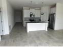 Modern kitchen with white cabinets, stainless steel appliances, and large island at 798 Kapi Dr, Groveland, FL 34736