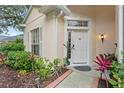 Inviting front entrance with decorative landscaping and charming details at 8495 Lake Amhurst Trl, Orlando, FL 32829