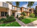 Inviting townhome with brick walkway, lush landscaping, and a charming facade with a covered entry at 9140 Grey Moss Dr, Orlando, FL 32832