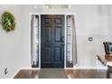 Elegant dark wood front door with side lights and transom window, complemented by a decorative wreath at 915 Lockbreeze Dr, Davenport, FL 33897