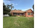 Inviting single-Gathering home with well-manicured lawn, colorful exterior, and classic architectural details at 1031 Kings Hwy, Kissimmee, FL 34744