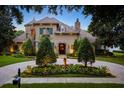 Stately two-story home with stone accents, lush landscaping, fountain and circular driveway at 11106 Coniston Way, Windermere, FL 34786