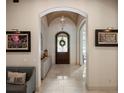 Elegant foyer featuring an arched doorway, tiled flooring, and decorative accents at 11106 Coniston Way, Windermere, FL 34786