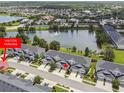 Aerial shot showcases townhomes near a serene lake with fountain in a well-maintained community at 1275 Shallcross Ave, Orlando, FL 32828