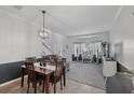 Open-concept dining room featuring tile floors, decorative lighting, and a smooth transition to the living room at 14680 Yorkshire Run Dr, Orlando, FL 32828