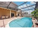 Screened-in pool area with lounge chairs and patio furniture, perfect for outdoor relaxation and entertaining at 14680 Yorkshire Run Dr, Orlando, FL 32828