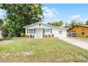 Inviting single-story home with a well-maintained lawn, complemented by vibrant green shutters at 1502 S Summerlin Ave, Sanford, FL 32771