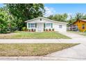 Welcoming home features a well-kept lawn, updated siding, and matching green shutters at 1502 S Summerlin Ave, Sanford, FL 32771