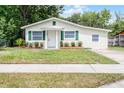 Beautiful single-story home with manicured lawn, fresh paint, and eye-catching green shutters at 1502 S Summerlin Ave, Sanford, FL 32771