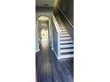 Inviting hallway with stylish gray flooring and a staircase, leading to the home's interior at 16449 Cedar Crest Dr, Orlando, FL 32828