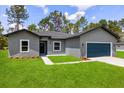Charming single-Gathering home featuring a well-manicured lawn, a two car garage, and professional landscaping at 17477 Sw 41St Cir, Ocala, FL 34473