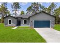 Charming single-Gathering home featuring a well-manicured lawn, a two car garage, and professional landscaping at 17477 Sw 41St Cir, Ocala, FL 34473