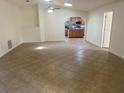 Open-concept living area with tiled floors, ceiling fan, and kitchen view at 211 Valencia Rd, Debary, FL 32713