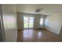 Bright living room with tile floors, a large window, and a view to the front yard at 211 Valencia Rd, Debary, FL 32713