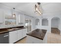 Bright eat-in kitchen features white cabinets, dark counters, island, and stainless steel appliances at 2255 Tealwood Cir, Tavares, FL 32778