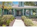 Inviting front entrance with decorative landscaping and covered porch area at 2283 Knollwood Dr, Leesburg, FL 34748