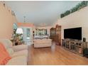 Bright living room featuring hardwood floors, comfortable seating, and an open layout, perfect for entertaining and Gathering gatherings at 2283 Knollwood Dr, Leesburg, FL 34748