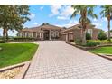 Gorgeous house with a 3-car garage, beautiful landscaping, a paver driveway and walkway at 23538 Valderama Ln, Sorrento, FL 32776