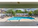 Inviting screened-in pool area with clear blue water, a sunbathing area, and nice plants at 2406 Blossomwood Dr, Oviedo, FL 32765