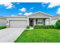 Charming single-story home with a well-manicured lawn and an attached two-car garage at 251 Brave Rd, Davenport, FL 33837
