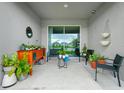 Cozy outdoor patio area with comfortable seating and view of the water at 251 Brave Rd, Davenport, FL 33837