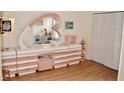 Spacious bedroom with ample closet space and a unique vanity with heart shaped mirror at 3012 S Semoran Blvd # S, Orlando, FL 32822