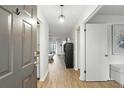 Bright hallway with modern flooring leading to open living area at 3012 S Semoran Blvd # S, Orlando, FL 32822