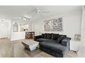 Well-lit living area with hardwood flooring, comfortable seating, and access to the kitchen at 3012 S Semoran Blvd # S, Orlando, FL 32822