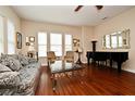 Elegant living room with hardwood floors, bright windows, and stylish furniture at 312 Trieste Loop, Lake Mary, FL 32746
