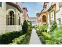 Charming community walkway with lush landscaping, leading through picturesque townhome exteriors at 312 Trieste Loop, Lake Mary, FL 32746