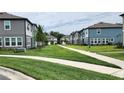 Picturesque view of townhomes lining a manicured green space, creating a serene neighborhood at 3248 Merton Aly, Orlando, FL 32808