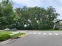 Scenic view of a quiet neighborhood street lined with lush trees and sidewalks at 3248 Merton Aly, Orlando, FL 32808