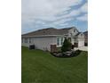 Landscaped yard surrounding a modern home, showcasing the home's exterior at 444 Halter Dr, Apopka, FL 32712