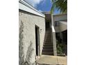 Close-up exterior view showcasing stairway to upper-level residences and textured facade at 5395 Vineland Rd # S, Orlando, FL 32811