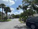 View of complex, highlighting lush landscaping, mature trees, and ample parking at 5395 Vineland Rd # S, Orlando, FL 32811