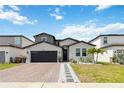 Inviting home exterior with brick driveway and beautifully landscaped front yard at 5639 Timber Meadow Way, St Cloud, FL 34771