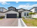 Charming two-story home featuring a brick driveway and beautiful landscaping at 5639 Timber Meadow Way, St Cloud, FL 34771
