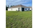 Home exterior with a screened lanai and green lawn at 7172 Sw 135Th Pl, Ocala, FL 34473