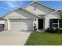 Charming home featuring a two-car garage, well-manicured lawn, and inviting front entry at 7172 Sw 135Th Pl, Ocala, FL 34473