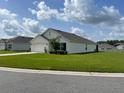 Single-story home with a manicured lawn, two car garage, and neatly trimmed landscaping at 7172 Sw 135Th Pl, Ocala, FL 34473
