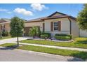 Beautifully landscaped front yard with decorative stone and lush green shrubs at 914 Fallon Hills Dr, Haines City, FL 33844