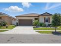 Well-maintained home exterior with a paved driveway and manicured lawn at 914 Fallon Hills Dr, Haines City, FL 33844