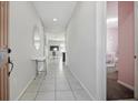Bright hallway with tile flooring, leading to various rooms in the house at 914 Fallon Hills Dr, Haines City, FL 33844
